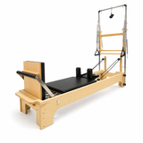 Bodylumina Premium Gold pilates tower reformer s drvenim okvirom, crnom kliznom platformom, metalnim tornjem, oprugama, trakama i podesivim footbar osloncem, profesionalna pilates sprava za tower reformer trening, jačanje core mišića, istezanje, stabilnost, rehabilitaciju i oblikovanje tijela kod kuće ili u studiju.